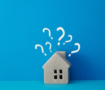 Real estate developer and managing property investment concept. houses with question mark on blue background